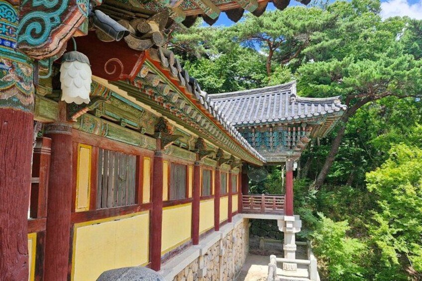A traditional Korean building with ornate architecture, including a tiled roof and colorful wooden panels. 4