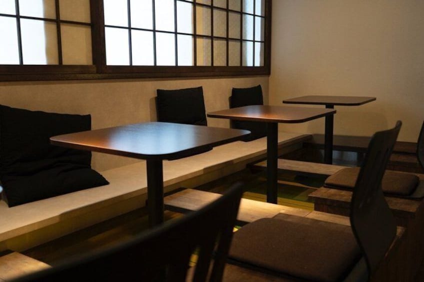 A traditional Japanese-style restaurant with tatami mat seating and low tables. 3