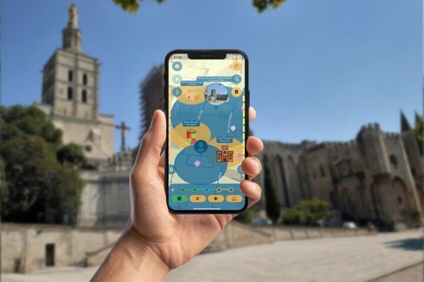 A hand holding a smartphone with a map application, a historic building, and a clear blue sky in the background. 3