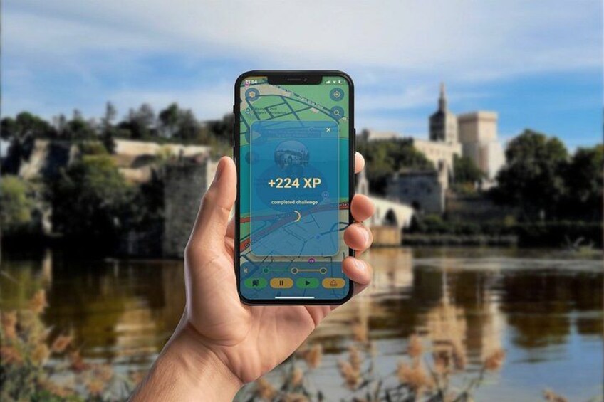 A hand holding a smartphone displaying a map with a completed challenge notification. 5