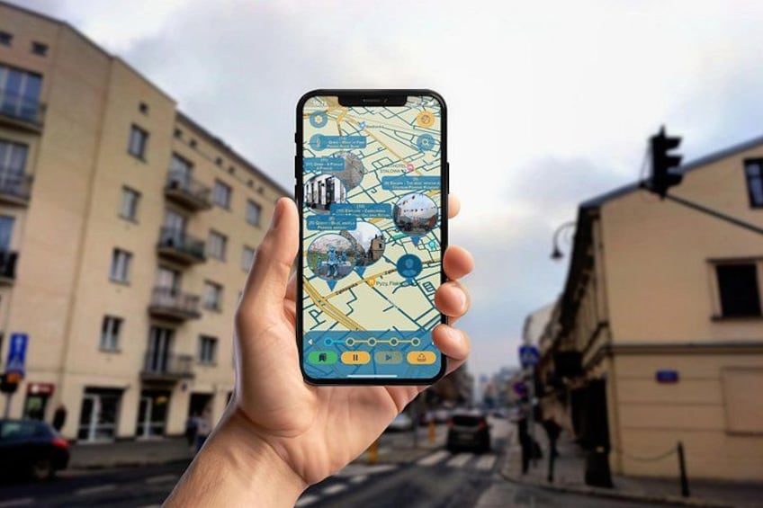 A hand holding a smartphone displaying a map with various icons and a compass. 1