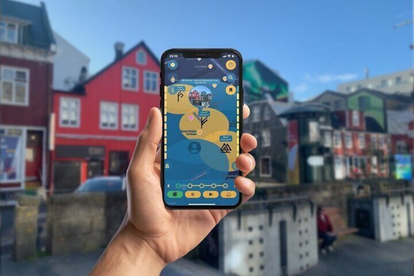 A hand holding a smartphone displaying a map with various icons and a time of 23:15. 1
