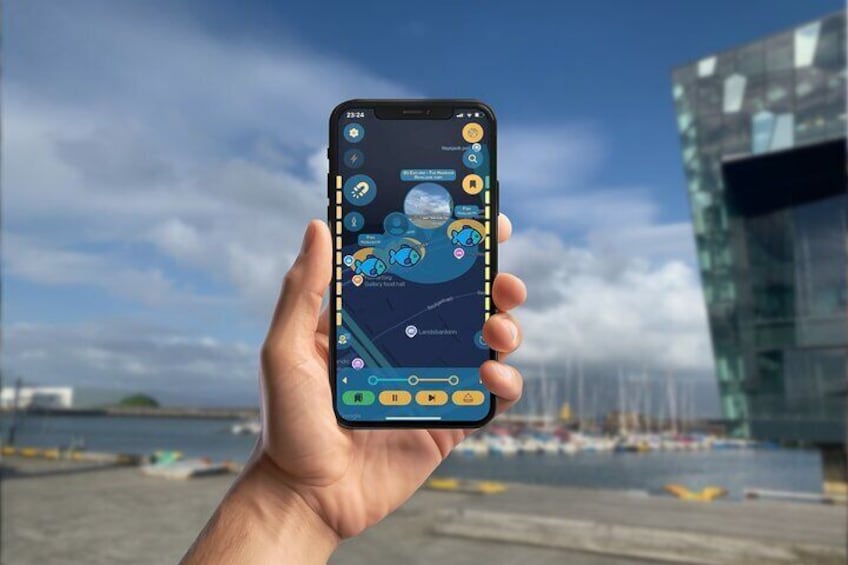 A hand holding a smartphone displaying a map with icons, a time of 23:24, and a clear sky with clouds. 5