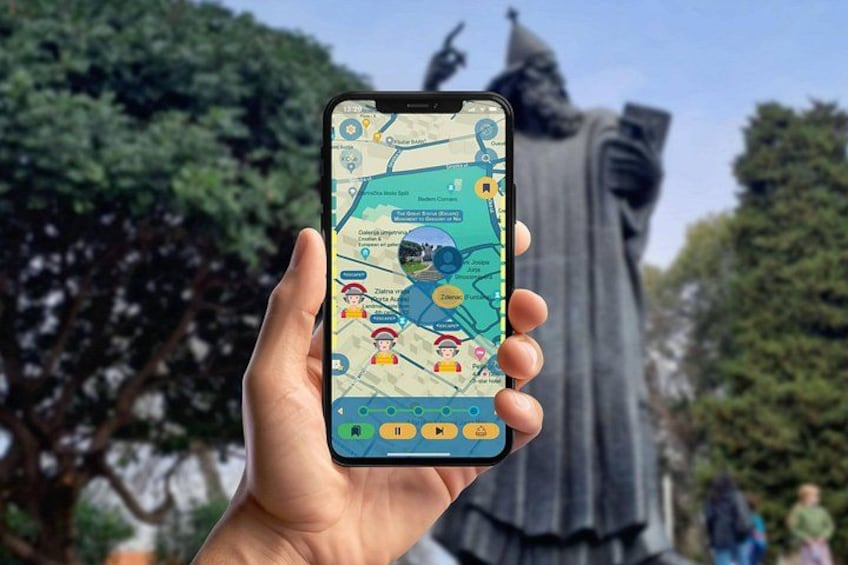 A hand holding a smartphone displaying a map with icons and text, with a statue in the background. 4