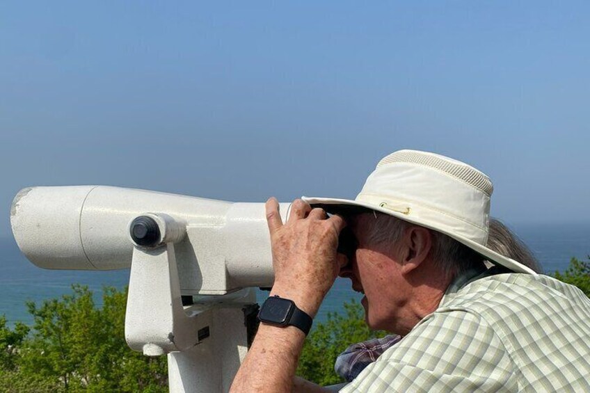 A person using a telescope. 3