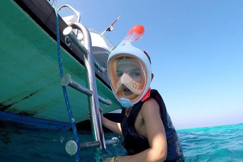 A person snorkeling near a boat. 2