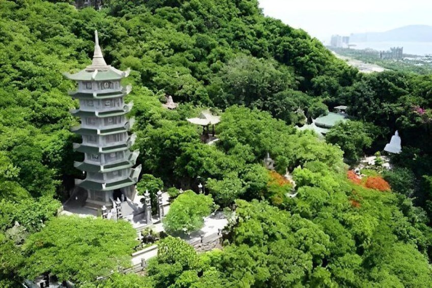 A pagoda surrounded by lush greenery and a river. 5