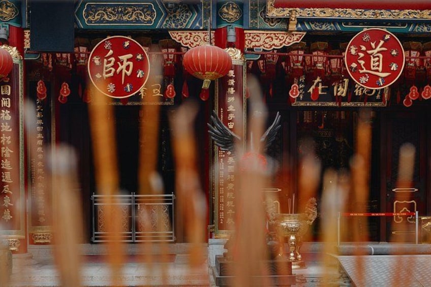 A traditional Chinese temple with ornate decorations, red lanterns, and Chinese characters. 5
