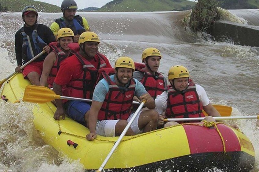 A group of people in a yellow raft navigating a river. 5