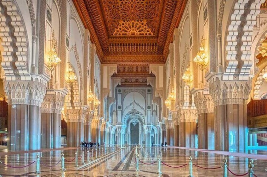 An ornate interior with intricate architectural details, including a grand ceiling and arched doorways. 1