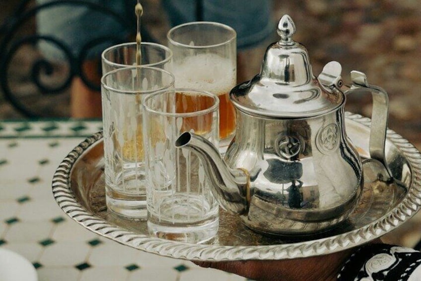 A silver teapot and glasses on a tray. 3