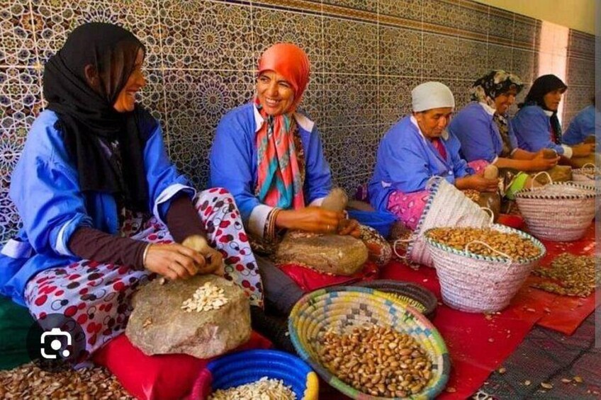 People sitting on the ground, sorting and selling nuts at a market. 4