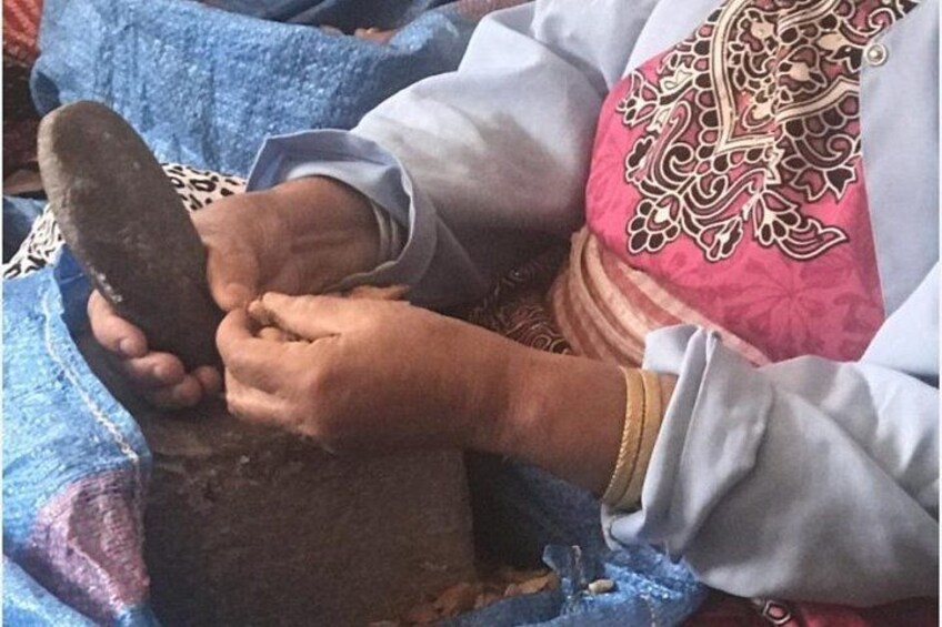 A person holding a stone. 5