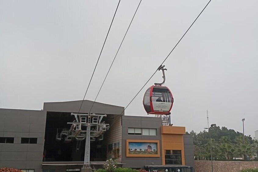 A cable car system, a building with a large sign, and a mural. 1