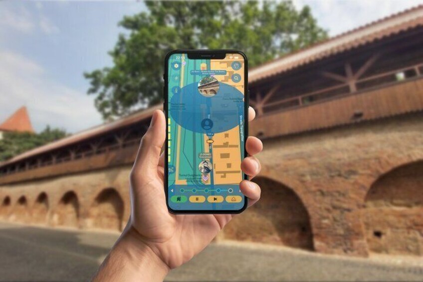 A hand holding a smartphone with a map application, a bridge with arches, and a tree in the background. 2