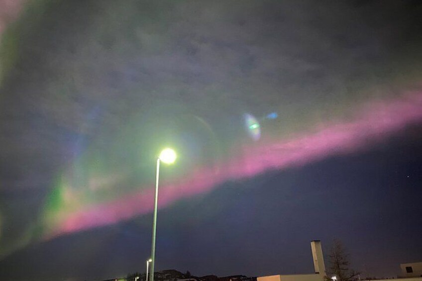A night sky with a streetlight and aurora borealis. 5