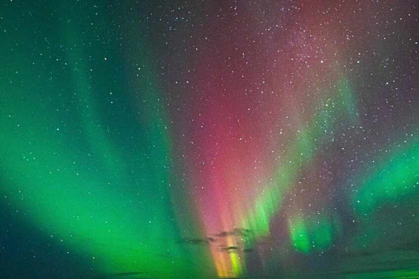 The aurora borealis with green and red hues. 1