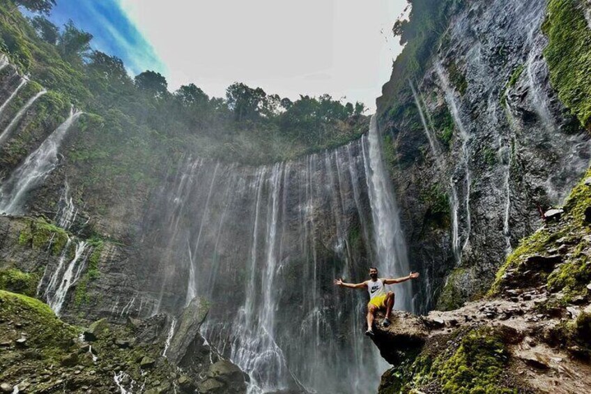 A waterfall with multiple streams cascading down a rocky cliff. 1