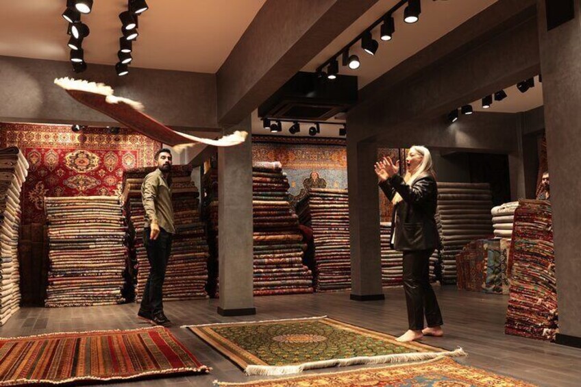 A carpet store with stacks of carpets and rugs. 1