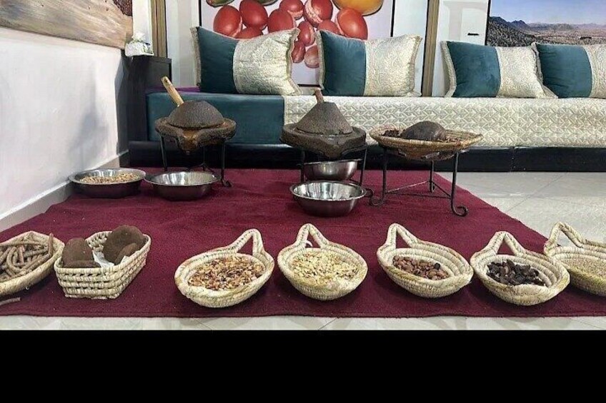 A living room with a sofa, cushions, and a rug. There are several woven baskets on the rug containing various items. 5