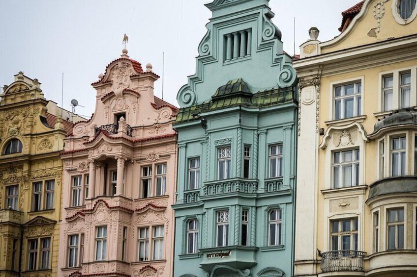 A row of colorful historic buildings with ornate facades and detailed architectural features. 4