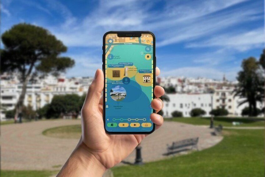 A hand holding a smartphone displaying a map with a park and buildings in the background. 5