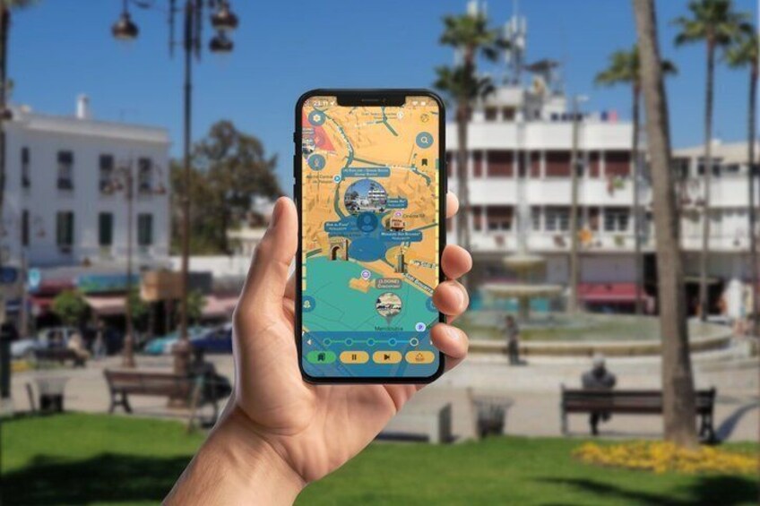 A hand holding a smartphone displaying a map with a blue icon, palm trees, and a building in the background. 4