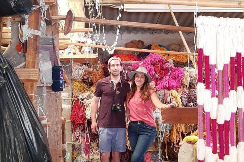 A market stall with various colorful ropes and textiles. 2