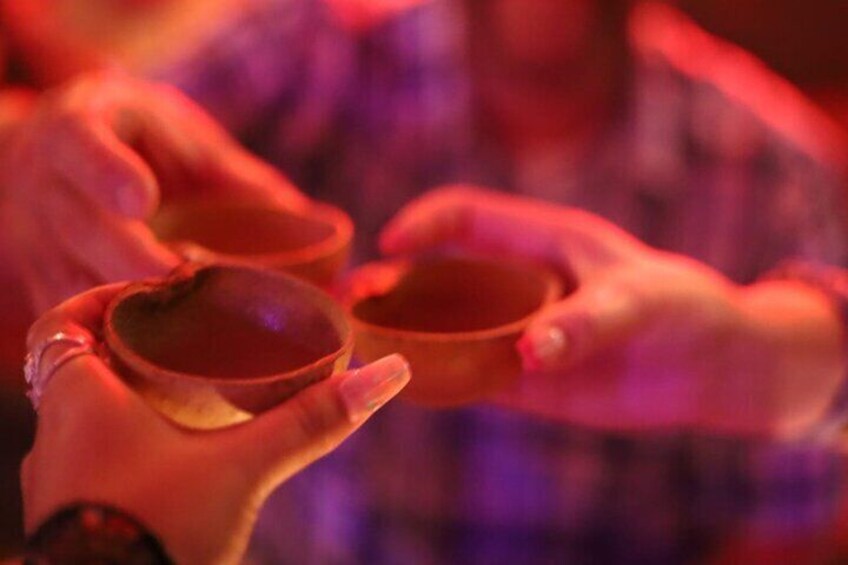 A person holding a small, round, brown object. 2