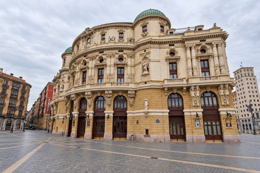 A historic building with ornate architecture, large arched windows, and a dome. 2