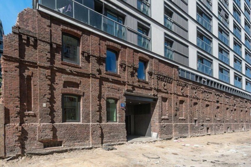 A historic brick building with a modern glass extension. 2