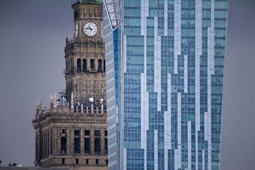 A historic clock tower and a modern glass skyscraper. 3