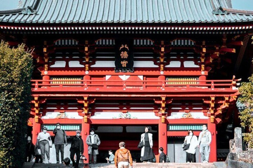 A traditional Japanese building with red pillars and a tiled roof. 4