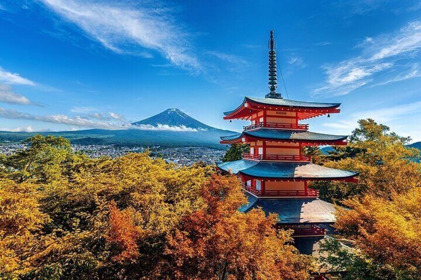 A multi-tiered pagoda with a mountain in the background. 2