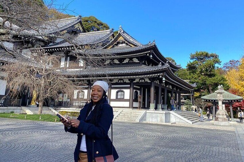 A traditional Japanese building with a curved roof and wooden pillars. 5