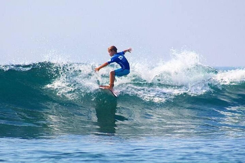 A person surfing a wave in the ocean. 5