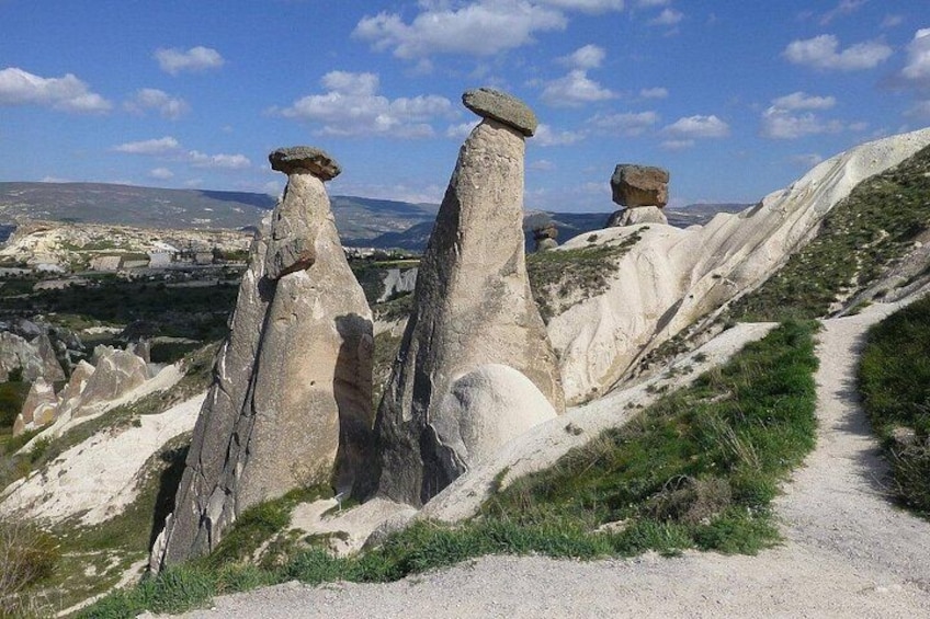 A rocky landscape with prominent rock formations and a dirt path. 3
