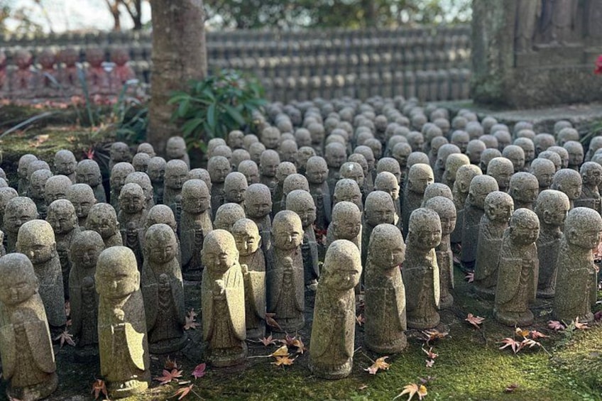 A large number of stone statues arranged in rows. 4
