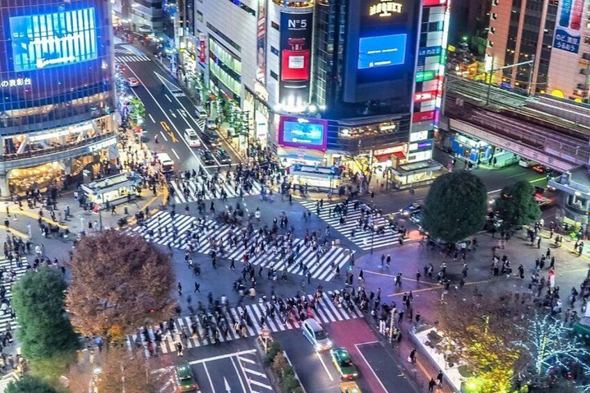 A busy urban intersection with crosswalks and tall buildings. 5