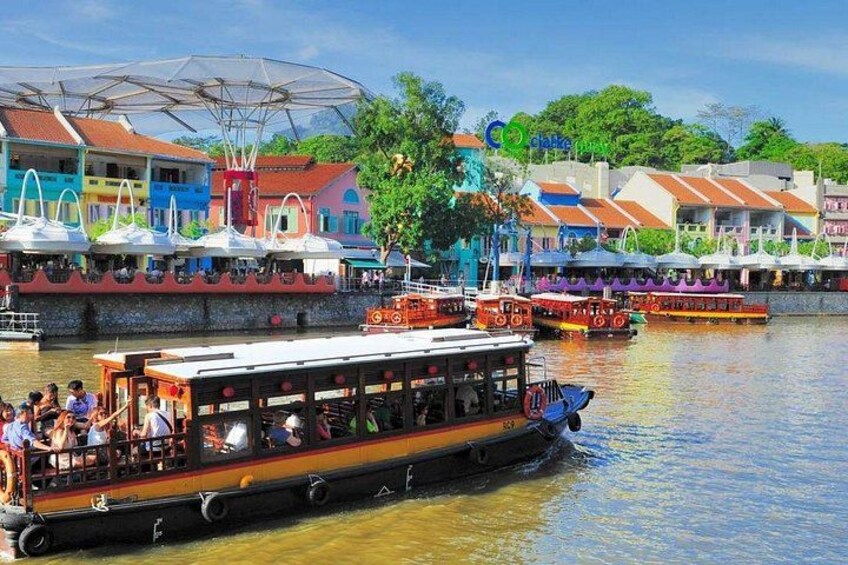 A river with boats, a waterfront with colorful buildings, and a large umbrella structure. 3