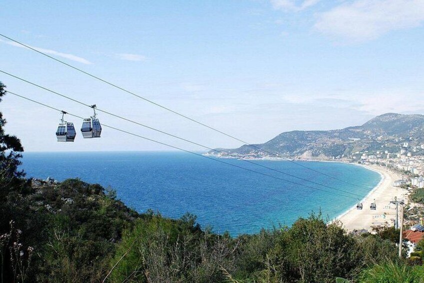 A cable car system, a beach, and a coastal town. 3