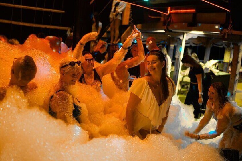 People in a foam-filled area with a structure overhead. 3