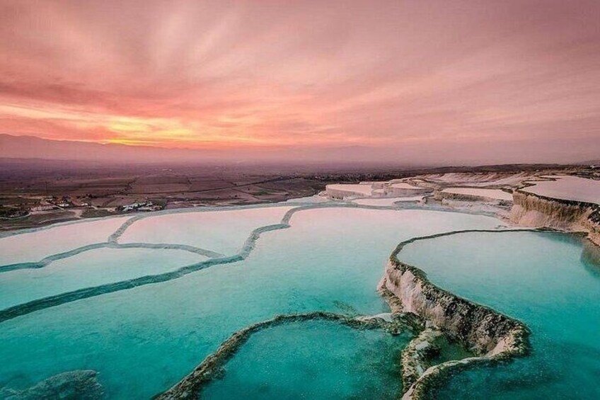 Terraced pools with clear turquoise water, surrounded by natural rock formations. 1