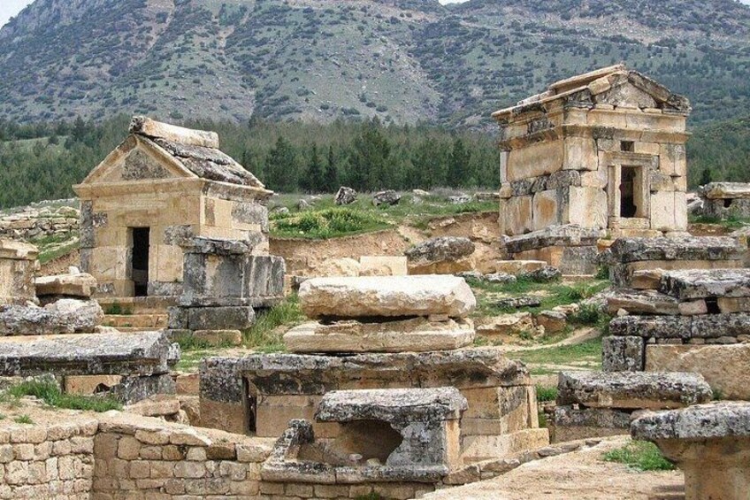 Ancient stone ruins with a mountain backdrop. 3