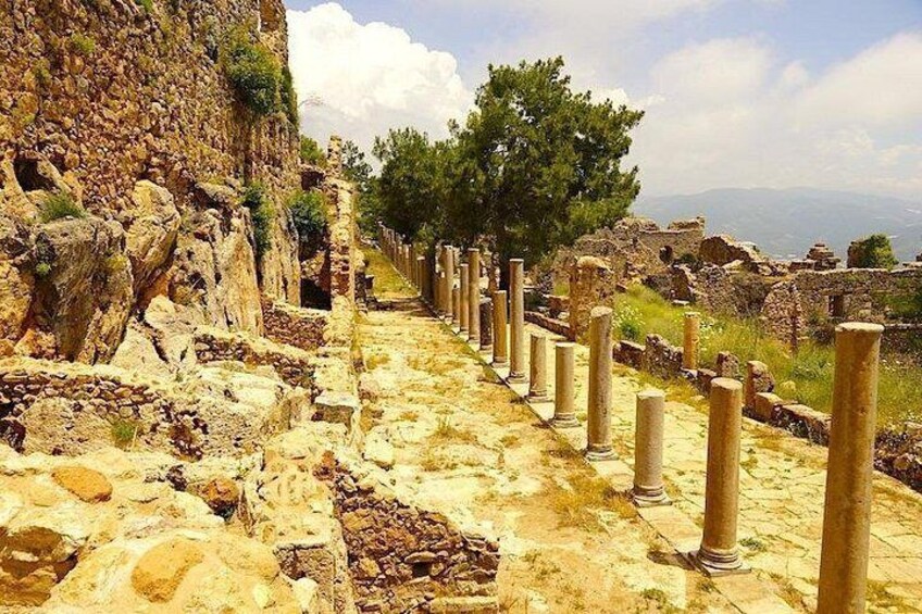 Ancient ruins with stone columns and a stone pathway. 3