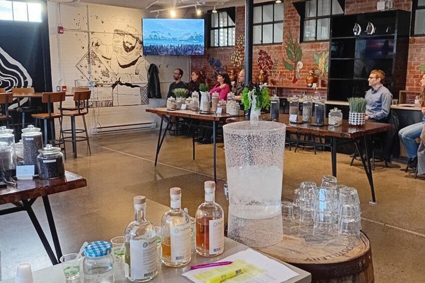 A café with tables, chairs, and various drink bottles and glasses. 5