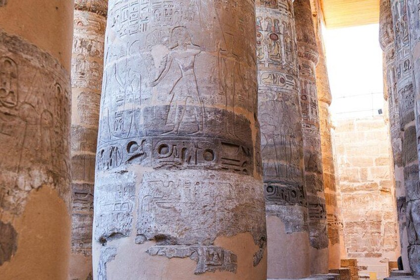 Ancient Egyptian columns with hieroglyphs and carvings. 3