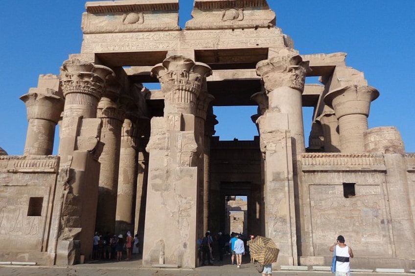 A large stone structure with columns and a central doorway. 1