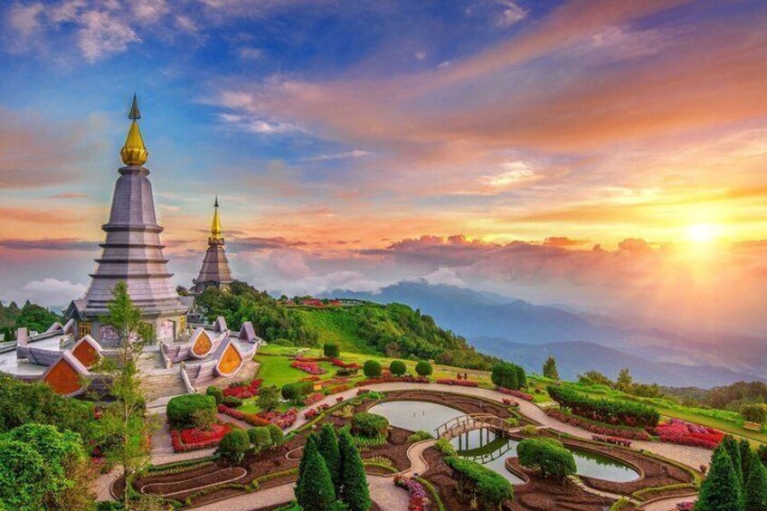 A temple complex with tiered roofs and a garden with ponds and pathways. 1