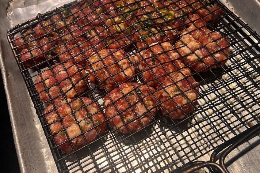 A grill with meat and vegetables. 4